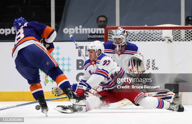 Adam Fox and Igor Shesterkin of the New York Rangers defend against Anthony Beauvillier of the New York Islanders during the first period at the...