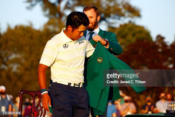 Hideki Matsuyama of Japan is awarded the Green Jacket by 2020 Masters champion Dustin Johnson of the United States during the Green Jacket Ceremony...