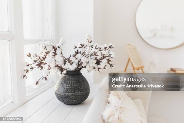 empty couch with beautiful pillow and vase with flowers. - cotton plant in vase stock pictures, royalty-free photos & images