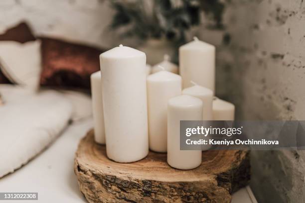 flowers composition. white candles and willow branches on white wooden background. spa - candle white background stock-fotos und bilder