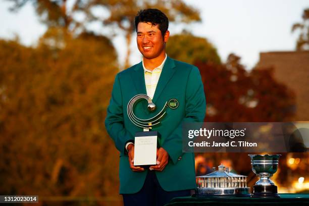 Hideki Matsuyama of Japan poses with the Asia Pacific Amateur Championship trophy during the Green Jacket Ceremony after winning the Masters at...