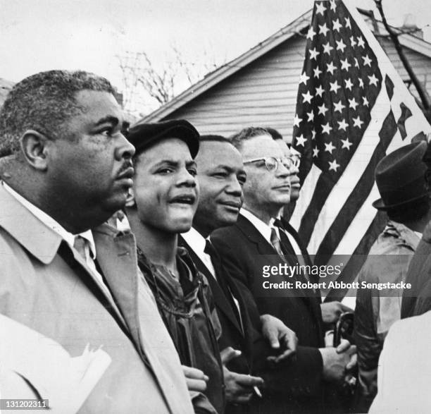 View of American newspaper publisher John H. Sengstacke and his son Lewis and others during on the Selma to Montgomery marches held in support of...