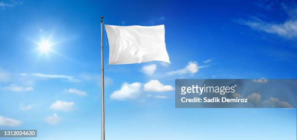 waving white flag at flagpole - aufgeben stock-fotos und bilder