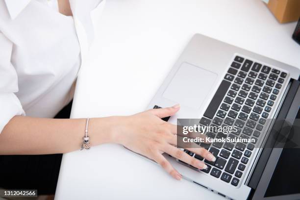 close up of women's hand is business working by touching laptop keyboard - tecla enter fotografías e imágenes de stock