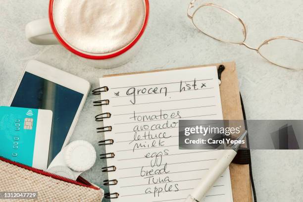 top view feminine handbag with coffee and shopping lidt - lista della spesa foto e immagini stock