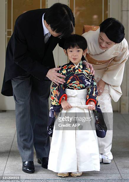 Japan's Prince Hisahito wearing traditional ceremonial attire is accompanied by his father Prince Akishino and mother Princess Kiko after the...