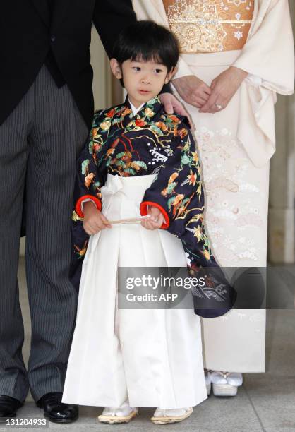 Japan's Prince Hisahito wearing traditional ceremonial attire is accompanied by his father Prince Akishino and mother Princess Kiko after the...