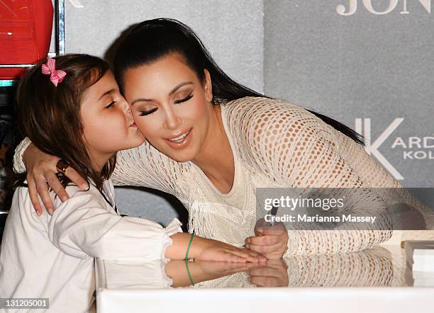 Kim Kardashian kisses a young fan at a promotion for the Kardashian Kollection Handbag range at the on November 3, 2011 in Sydney, Australia.