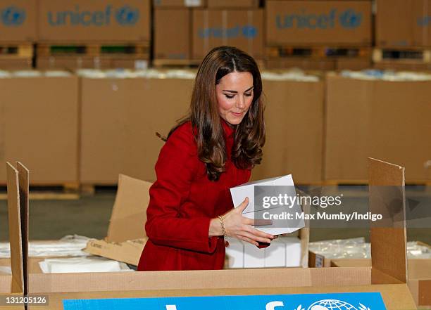 Catherine, Duchess of Cambridge helps to pack relief boxes as she visits the UNICEF emergency supply centre on November 2, 2011 in Copenhagen,...