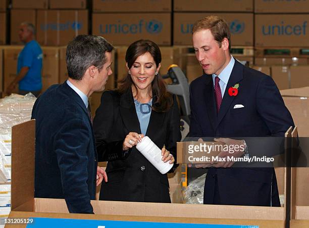 Crown Prince Frederik of Denmark , Crown Princess Mary of Denmark and Prince William, Duke of Cambridge help to pack relief boxes as they visit the...
