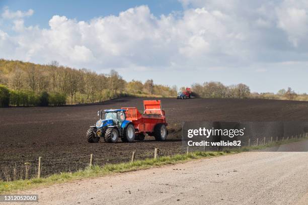 tractors muck spreading - craps stock pictures, royalty-free photos & images