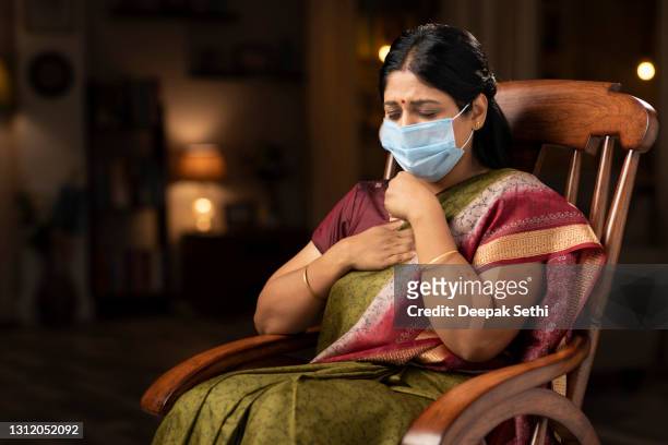 corona virus infected woman wearing protective mask showing symptoms of breathing issue and discomfort:- stock photo - india woman stock pictures, royalty-free photos & images