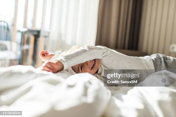 beautiful girl having morning stretch - bed sun stock pictures, royalty-free photos & images