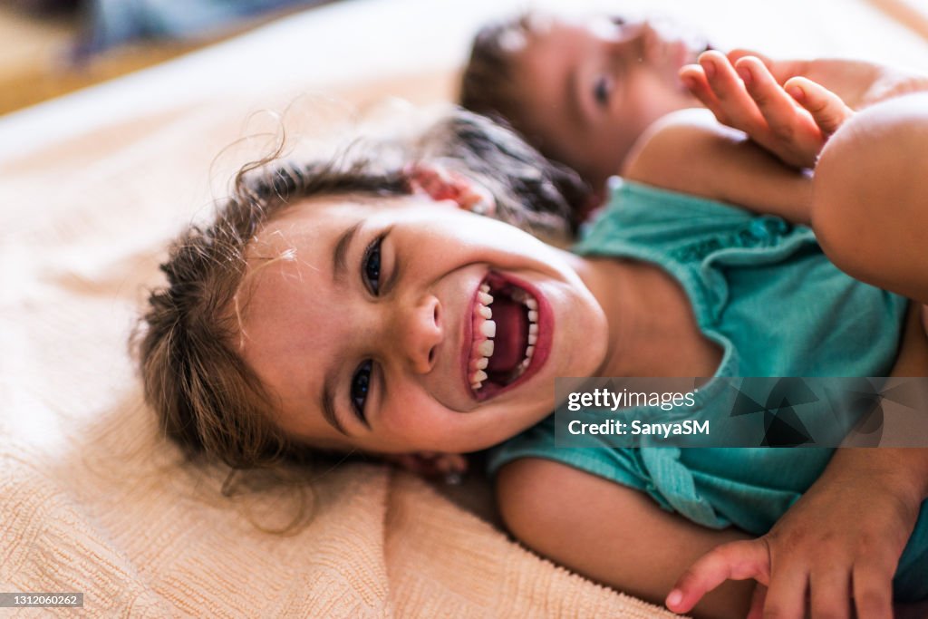 Beautiful children playing on the bed
