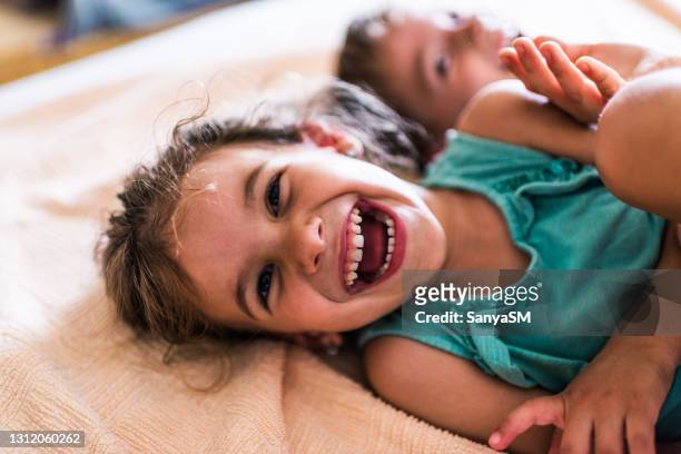 beautiful children playing on the bed - children only stock pictures, royalty-free photos & images