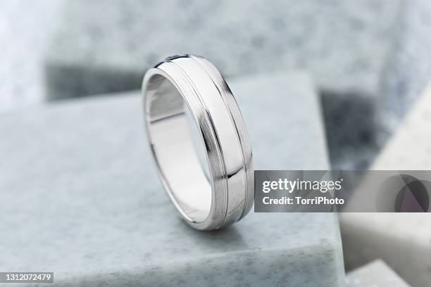 silver jewelry ring on gray stone background - white hat fashion item stock-fotos und bilder