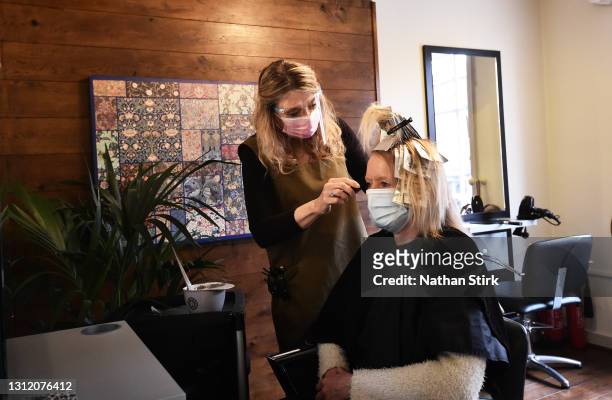 Amanda Sidley, owner of Bronte's Hair Boutique, colors a customers hair after reopening on April 12, 2021 in Leek, England. England has taken a...