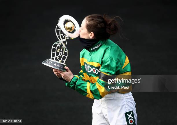 Jockey Rachael Blackmore receives the Randox Grand National Handicap Chase trophy after winning on Minella Times during Grand National Day of the...