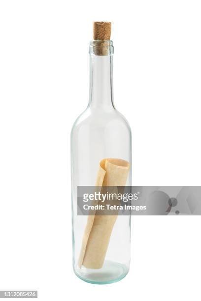 studio shot of glass bottle with message inside - message in a bottle stock pictures, royalty-free photos & images