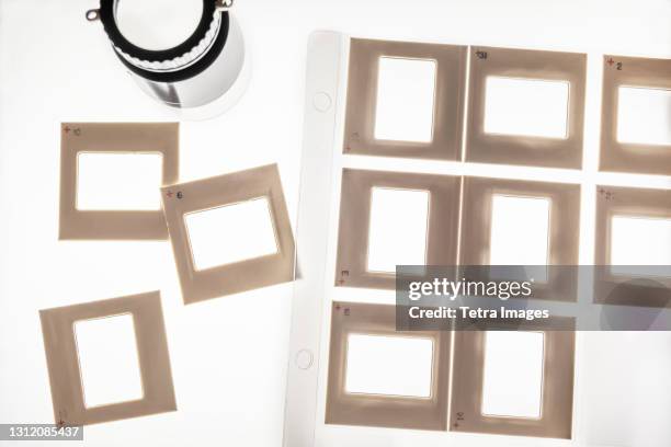 studio shot of blank slide film transparencies on lightbox - photographic slide stock pictures, royalty-free photos & images