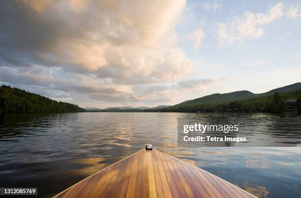 united states, new york, lake placid, wooden boat on lake placid at sunset - lake placid stock pictures, royalty-free photos & images