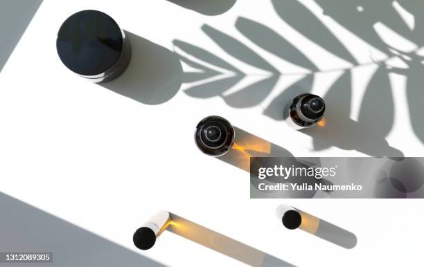 a set of cosmetic products with hard shadows - green room stockfoto's en -beelden