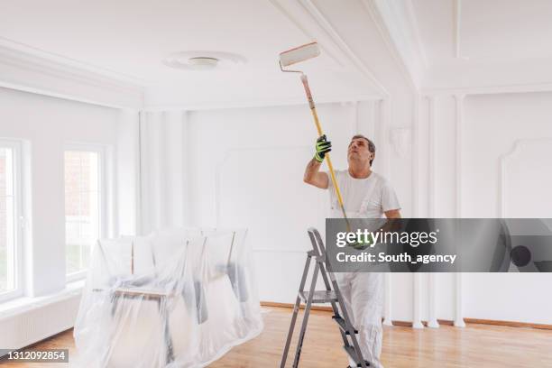 male painter painting a ceiling - painted ceiling stock pictures, royalty-free photos & images