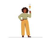 Black woman points on light bulb over her. Happy African female entrepreneur has business idea. Concept of innovation, solution and creativity.