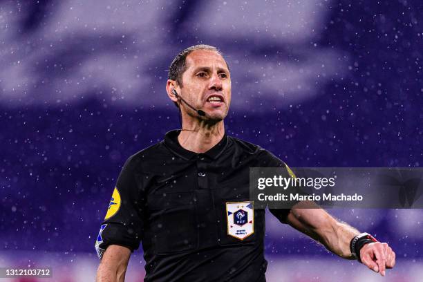 Referee Mikael Lesage gestures during the Ligue 1 match between Olympique Lyon and Angers SCO at Groupama Stadium on April 11, 2021 in Lyon, France.