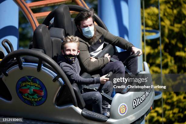 Thrill seekers wear face masks as they ride "The Spinball Whizzer" rollercoaster at Alton Towers on the first day opening after after lockdown...