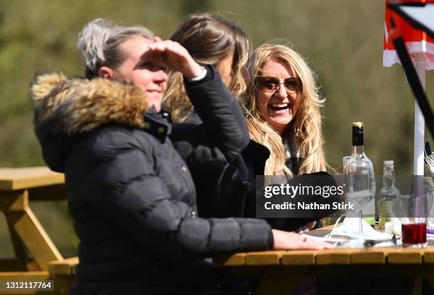 People enjoy a drink whilst in a beer garden at Hotel Rudyard on April 12, 2021 in Leek, England. England has taken a significant step in easing its...