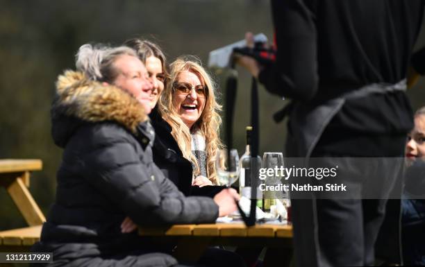 People enjoy a drink whilst in a beer garden at Hotel Rudyard on April 12, 2021 in Leek, England. England has taken a significant step in easing its...