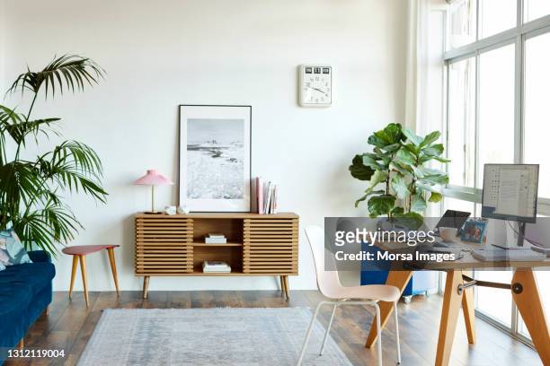 interior of home office with computer at table - 無人 ストックフォトと画像