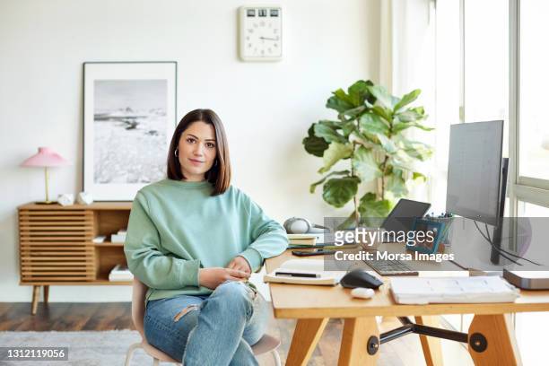 portrait of businesswoman at home office - business woman brown hair stock pictures, royalty-free photos & images