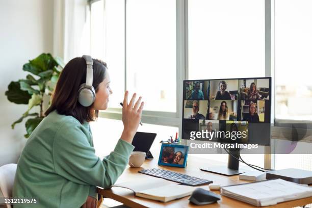 businesswoman discussing on video call in home office - telecommuting stock pictures, royalty-free photos & images