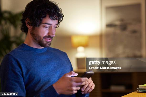 businessman using smart phone at home office - mann handy stock-fotos und bilder