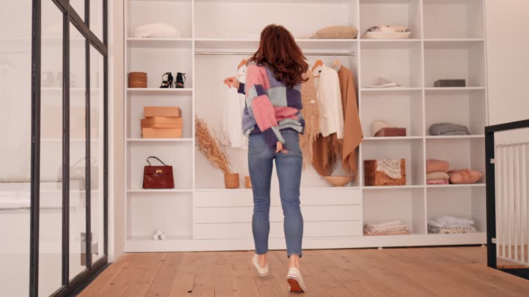 https://media.gettyimages.com/id/1312121513/video/cheerful-female-trying-on-outfits-in-wardrobe.jpg?b=1&s=640x640&k=20&c=bzfVli1IHwaQveUV_TEucaQEqGvW9YfXYyZN6hBCFIs=