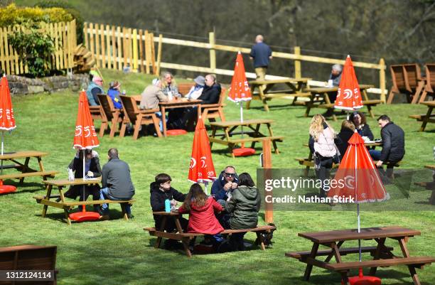 People enjoy food whilst in a beer garden at Hotel Rudyard on April 12, 2021 in Leek, England. England has taken a significant step in easing its...