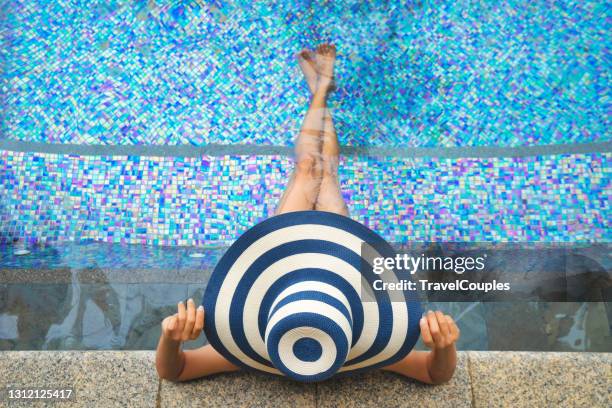 beautiful young woman in big straw hat in hot tub. women are relaxing at the poolside. woman relaxing in swimming pool spa. relaxing day in summer. summer luxury vacation. - big hot women bildbanksfoton och bilder