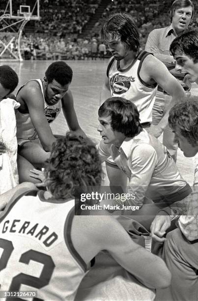 Denver Nuggets coach Larry Brown talks to his players in a huddle on the sideline during an ABA basketball game against the St. Louis Spirits at...