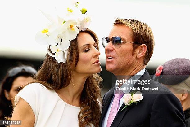 Shane Warne and Elizabeth Hurley attend the presentation of the Crown Oaks during Crown Oaks Day at Flemington Racecourse on November 3, 2011 in...