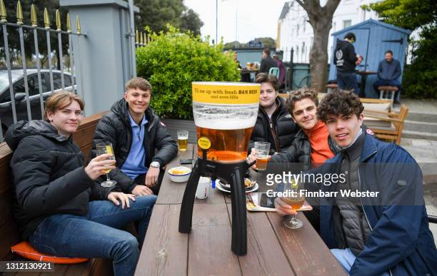 Members of the public enjoy food and a drink at Brewhouse & Kitchen pub at Southsea on April 12, 2021 in Portsmouth, England. England has taken a...