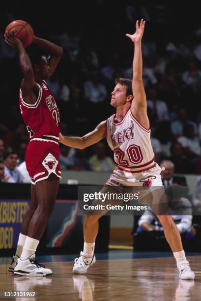 Jon Sundvold, Point Guard and Shooting Guard for the Miami Heat attempts to block the pass by Craig Hodges of the Chicago Bulls during their NBA...