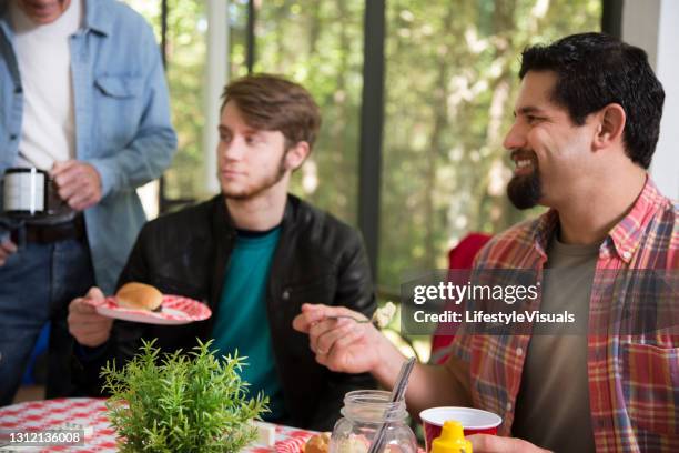 multi ethnic group of young men at a cook out. - brother in law stock pictures, royalty-free photos & images