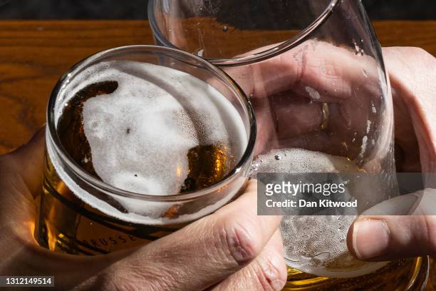 Two men enjoy pints of lager in Covent Garden on April 12, 2021 in London, United Kingdom. England has taken a significant step in easing its...