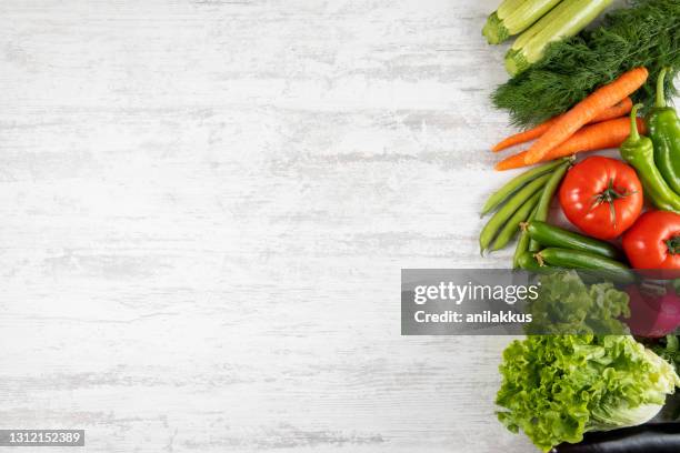 fresh and raw vegetables on wooden kitchen table - vegetables white background stock pictures, royalty-free photos & images