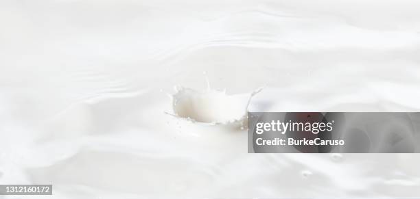 dropping into milk - milk wave stock pictures, royalty-free photos & images