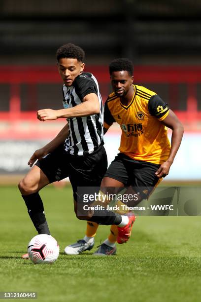 Christian Atsu of Newcastle United is challenged by Sadou Diablo of Wolverhampton Wanderers during the Premier League 2 match between Wolverhampton...