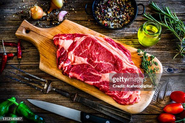 juicy raw angus beef fillet on rustic kitchen table - entrecôte stock pictures, royalty-free photos & images
