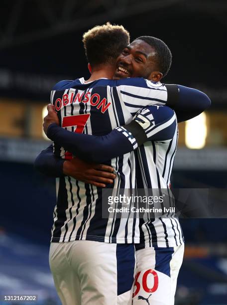 Callum Robinson of West Bromwich Albion celebrates after scoring their sides third goal with team mate Ainsley Maitland-Niles during the Premier...